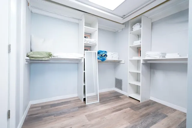 a kitchen with granite countertop a sink cabinets and wooden floor