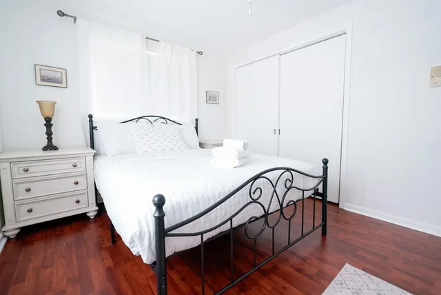 a bedroom with a bed and a dresser