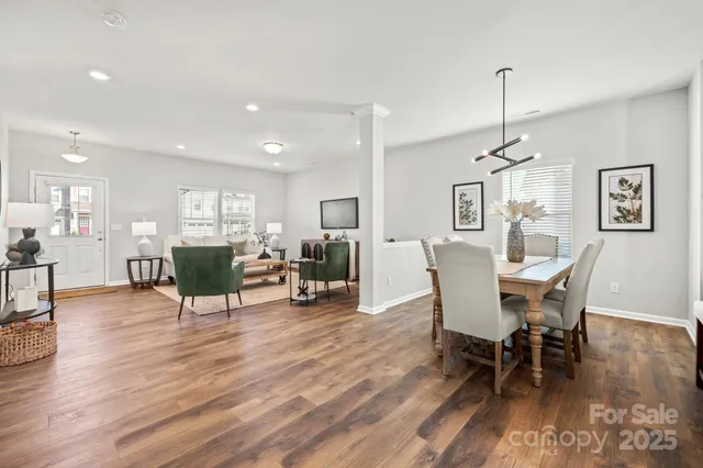 a kitchen with stainless steel appliances granite countertop a sink a stove a refrigerator and island with wooden floor