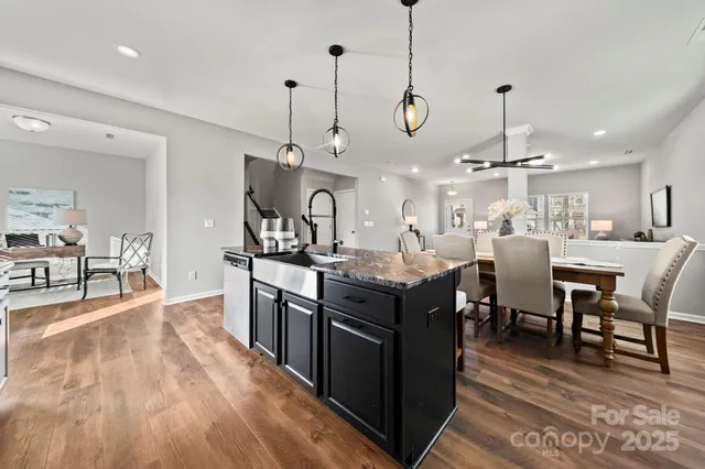 a kitchen with granite countertop white cabinets stainless steel appliances and sink
