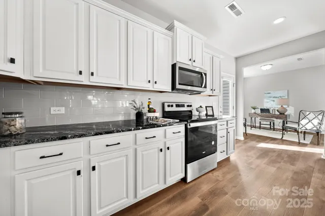 a work room with furniture wooden floor and a window