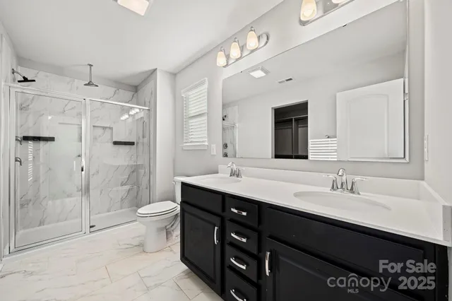 a bathroom with a sink double vanity and a mirror