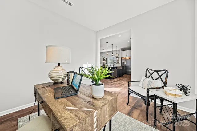 a view of a dining room with furniture and a potted plant