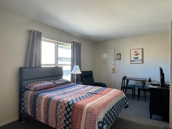 a bedroom with a bed and a table in it