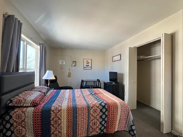 a bedroom with a bed and a window