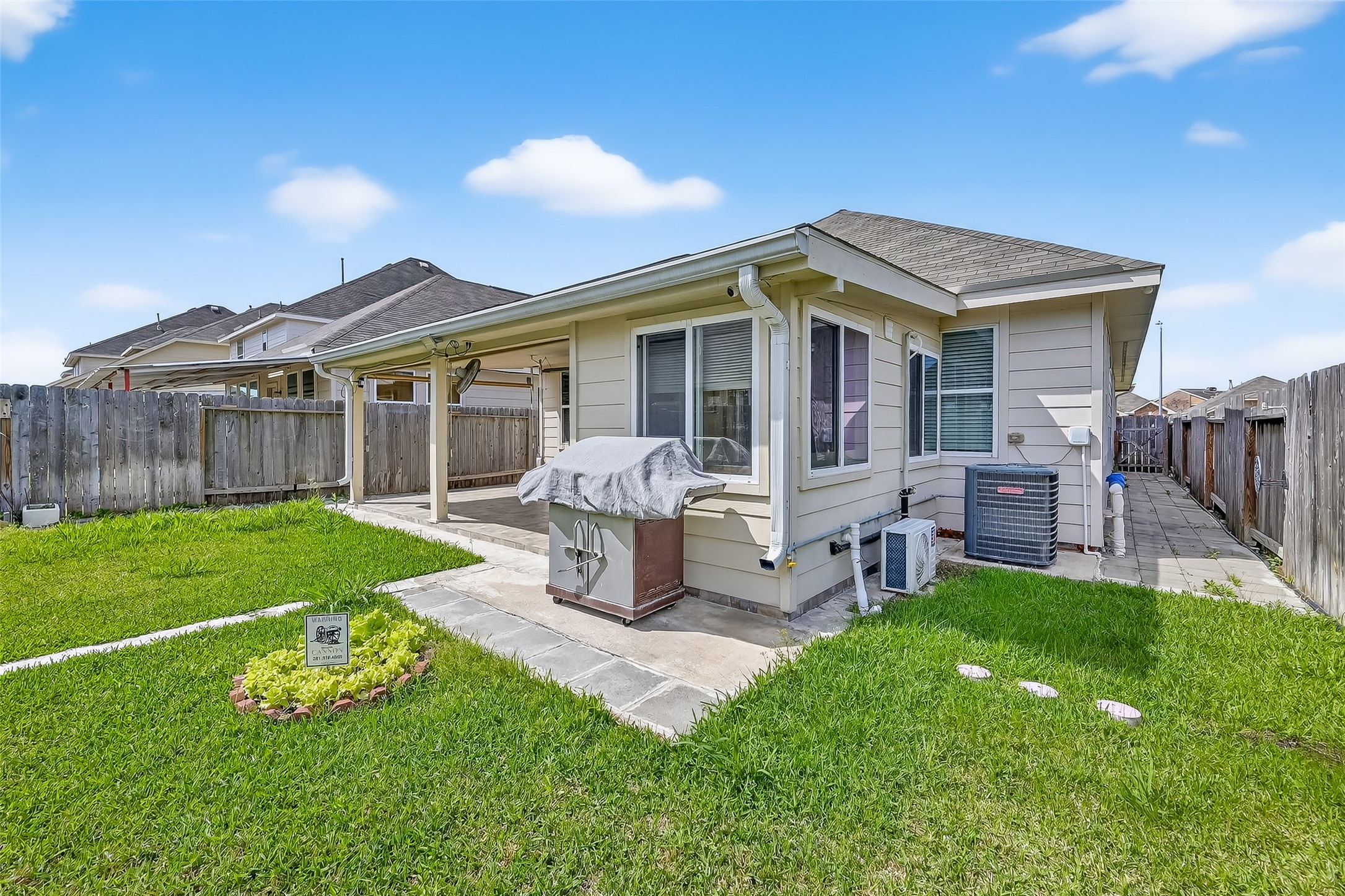 7631 Granite Terrace Lane Houston, TX 77083 - Photo 44 of 46 a front view of house with a garden and patio