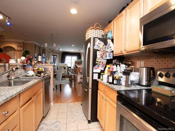 a kitchen with lots of counter top space and stainless steel appliances