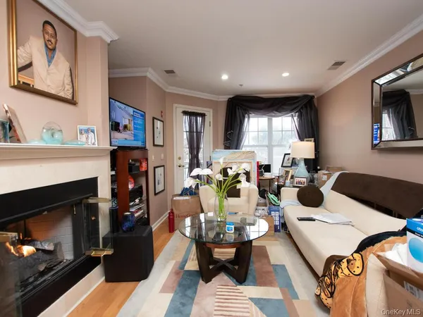 a living room with furniture fireplace and window