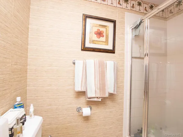 a bathroom with a sink a toilet and mirror