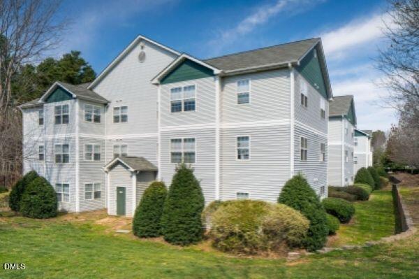 2000 University Woods Road, Unit 304 Raleigh, NC 27603 - Photo 2 of 8 a front view of a house with a yard