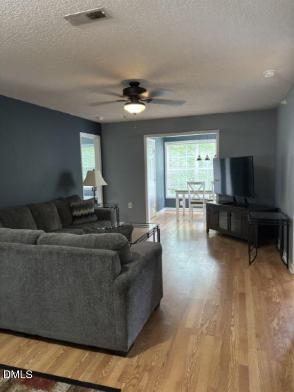 2000 University Woods Road, Unit 304 Raleigh, NC 27603 - Photo 4 of 8 a living room with furniture and a flat screen tv