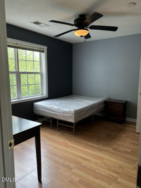 2000 University Woods Road, Unit 304 Raleigh, NC 27603 - Photo 6 of 8 a bedroom with a bed and a window
