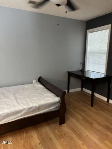 a bed sitting in a room next to a window