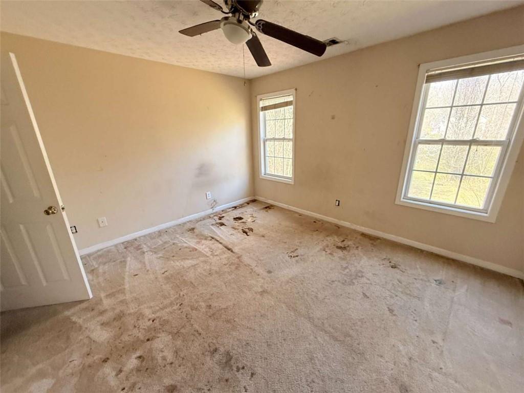 65 Montgomery Court Covington, GA 30016 - Photo 11 of 11 an empty room with windows and fan
