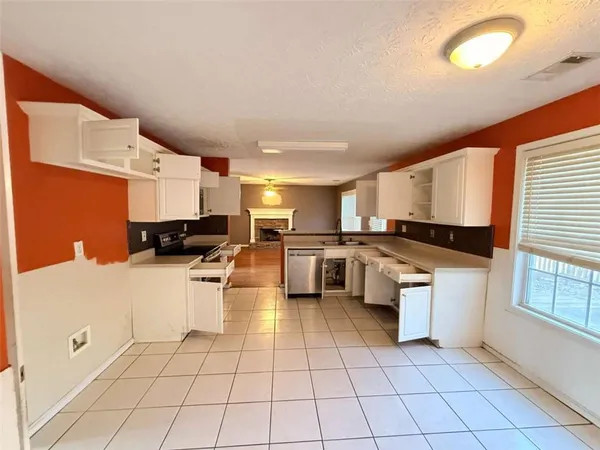 a kitchen with stainless steel appliances a refrigerator sink and cabinets