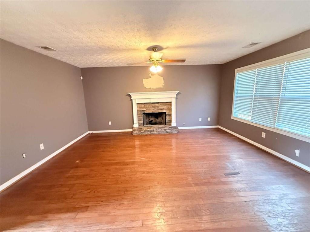 65 Montgomery Court Covington, GA 30016 - Photo 5 of 11 a view of an empty room with a fireplace and a window