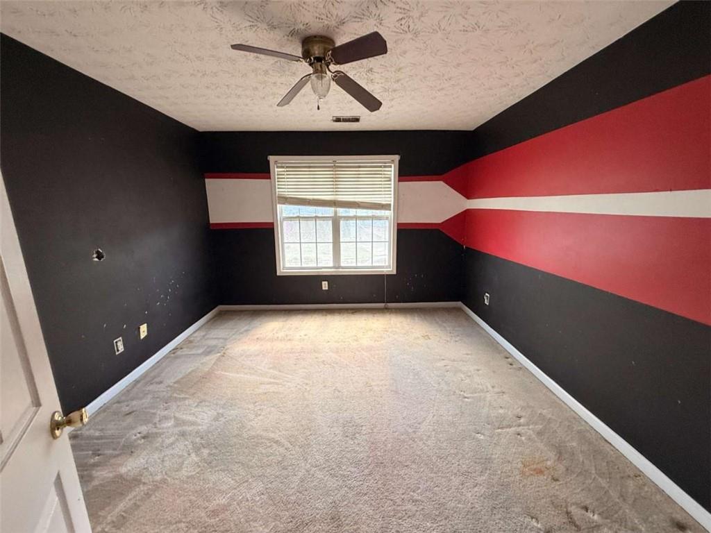65 Montgomery Court Covington, GA 30016 - Photo 6 of 11 wooden floor in an empty room with a window