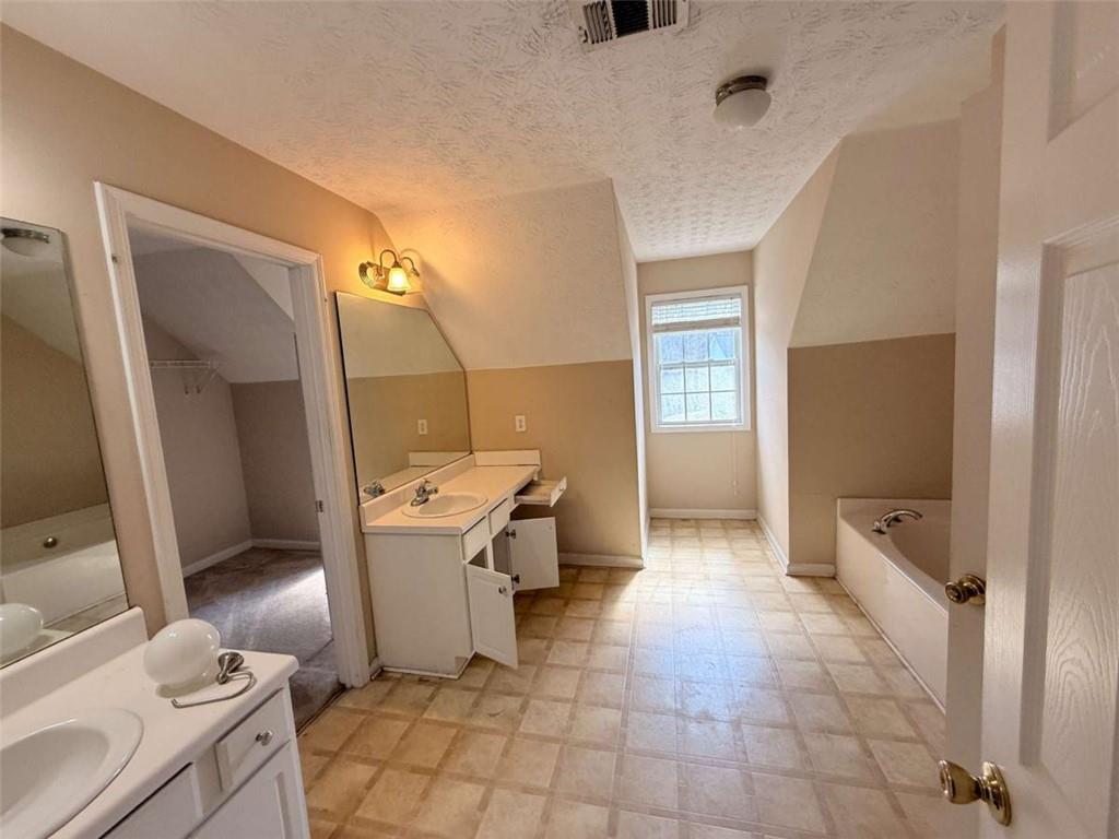 65 Montgomery Court Covington, GA 30016 - Photo 8 of 11 a bathroom with a sink a toilet and shower