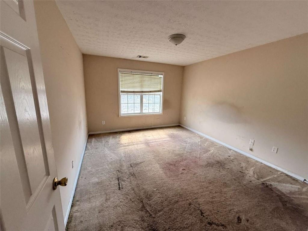 65 Montgomery Court Covington, GA 30016 - Photo 9 of 11 an empty room with windows