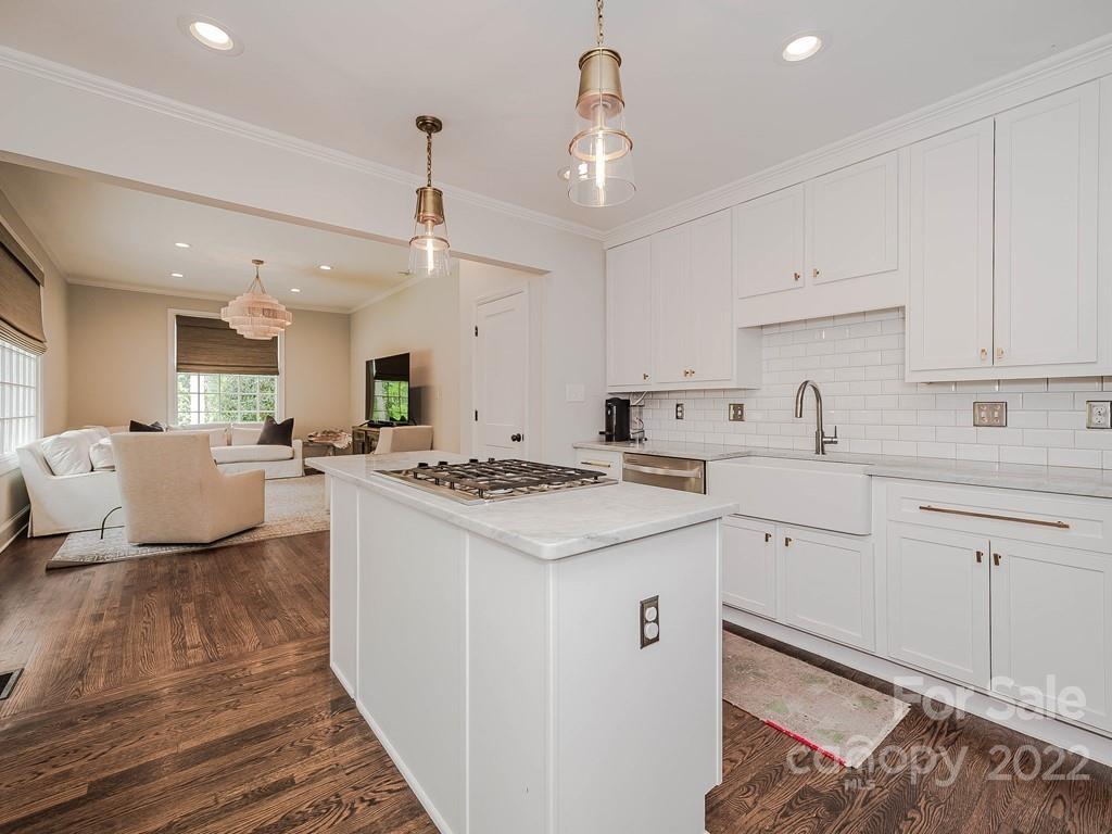 415 Ashworth Road Charlotte, NC 28211 - Photo 11 of 43 a kitchen with kitchen island a stove a sink a center island and cabinets