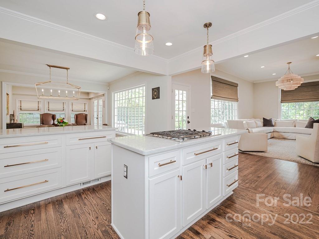 415 Ashworth Road Charlotte, NC 28211 - Photo 12 of 43 a kitchen with granite countertop a stove and white cabinets