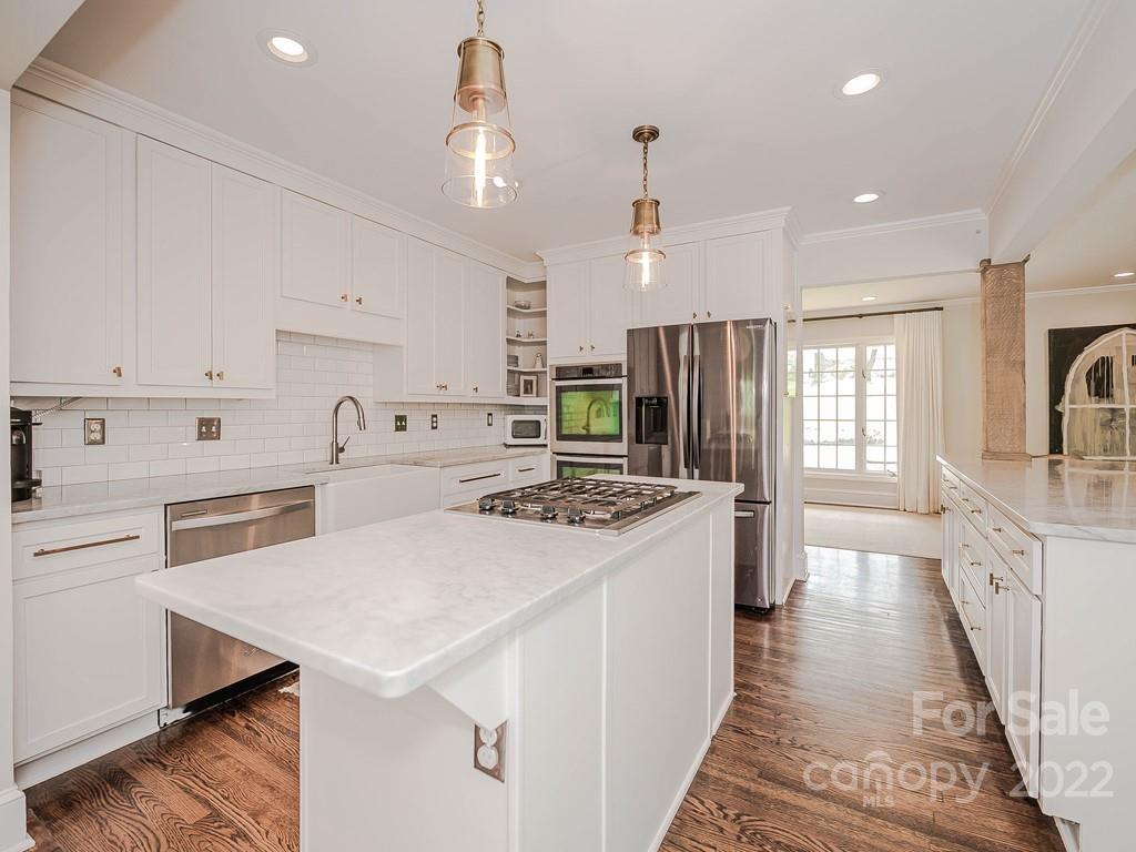 415 Ashworth Road Charlotte, NC 28211 - Photo 16 of 43 a kitchen with white cabinets sink and stove