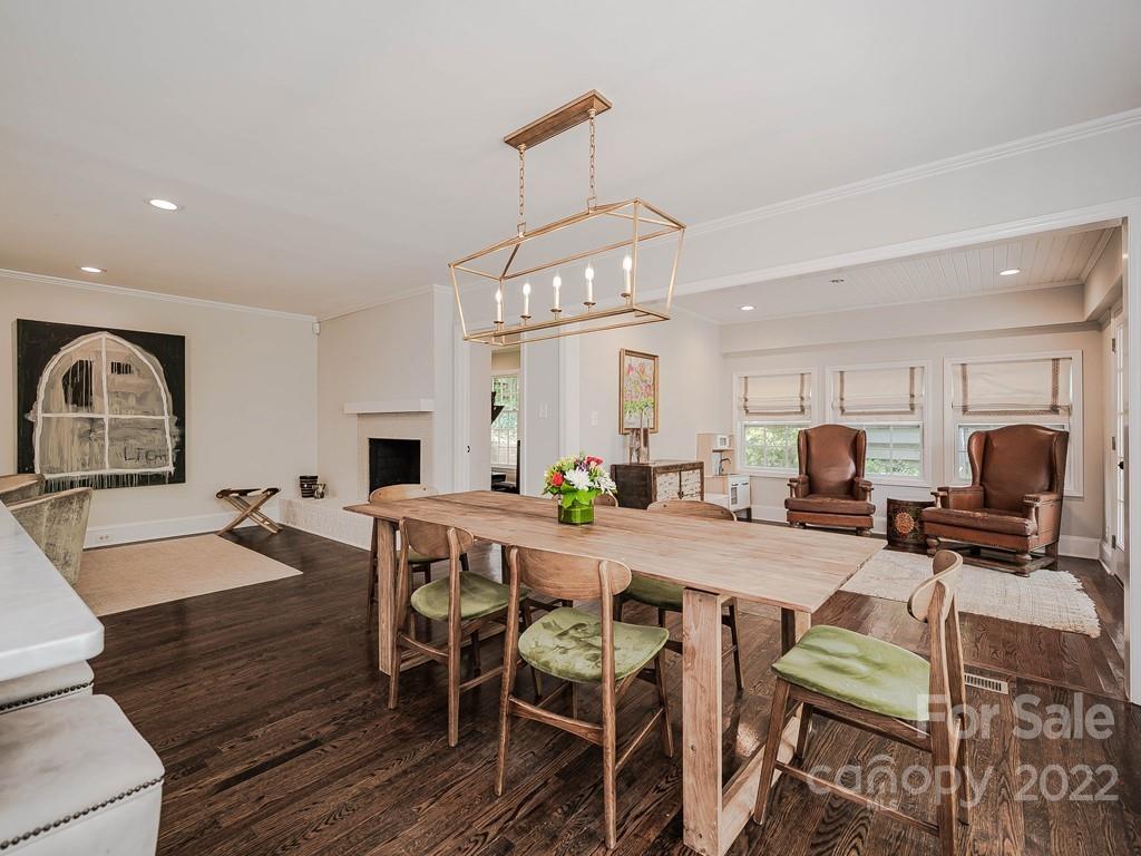 415 Ashworth Road Charlotte, NC 28211 - Photo 19 of 43 a view of a dining room with furniture a chandelier and wooden floor