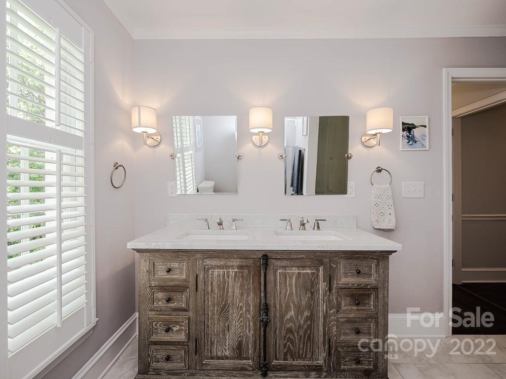 415 Ashworth Road Charlotte, NC 28211 - Photo 30 of 43 a bathroom with a double vanity sink and a mirror