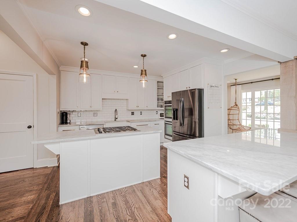 415 Ashworth Road Charlotte, NC 28211 - Photo 9 of 43 a kitchen with kitchen island a sink stove and refrigerator
