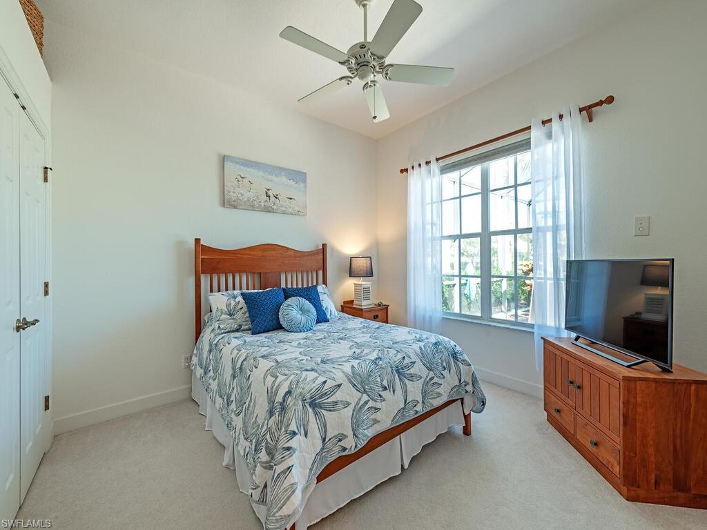 16105 Parque Lane Naples, FL 34110 - Photo 13 of 34 a bedroom with a bed and a flat screen tv
