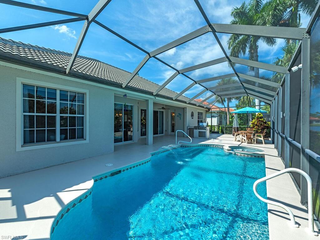 16105 Parque Lane Naples, FL 34110 - Photo 22 of 34 a view of a porch with furniture and a yard