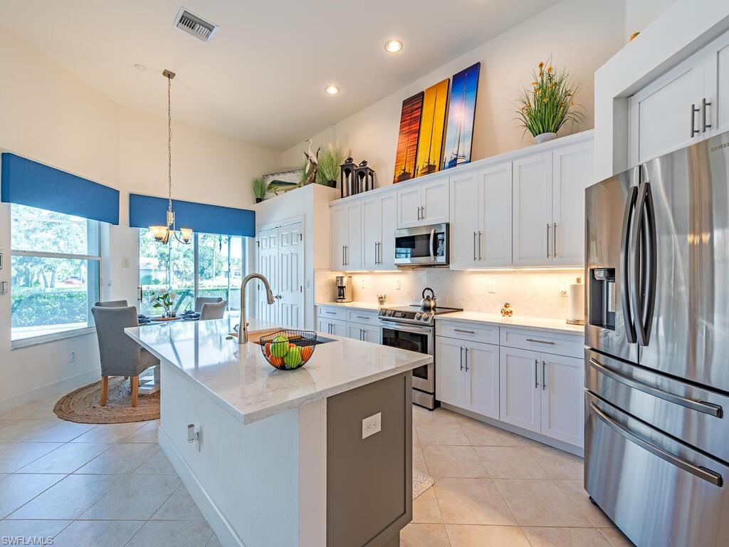 16105 Parque Lane Naples, FL 34110 - Photo 4 of 34 a kitchen that has a lot of cabinets in it and appliances