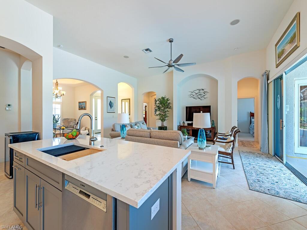 16105 Parque Lane Naples, FL 34110 - Photo 6 of 34 a view of a kitchen with granite countertop a dining table and chairs