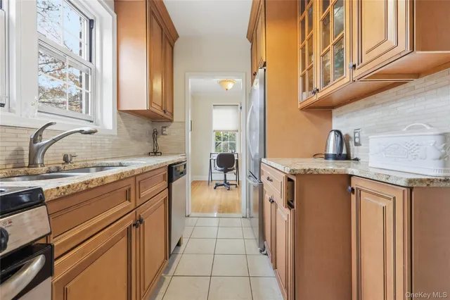 a kitchen with a stove a sink and a refrigerator