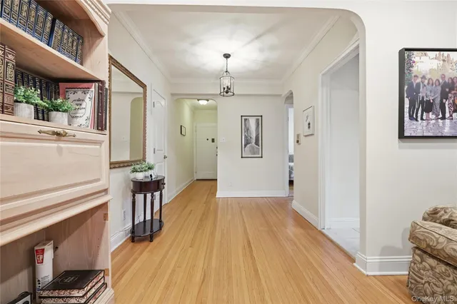 a living room with furniture and a book shelf