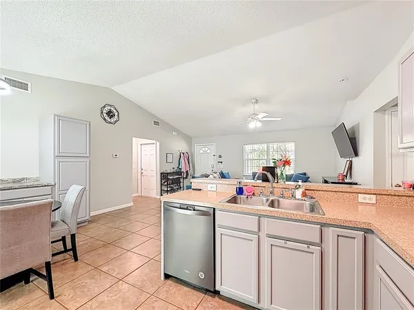 a kitchen with a sink cabinets and appliances