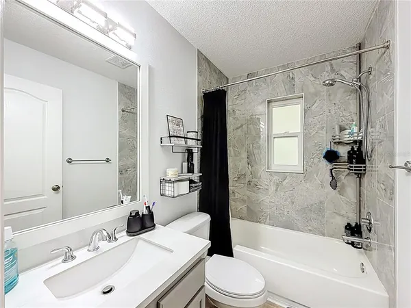 a bedroom with a bed and a large mirror