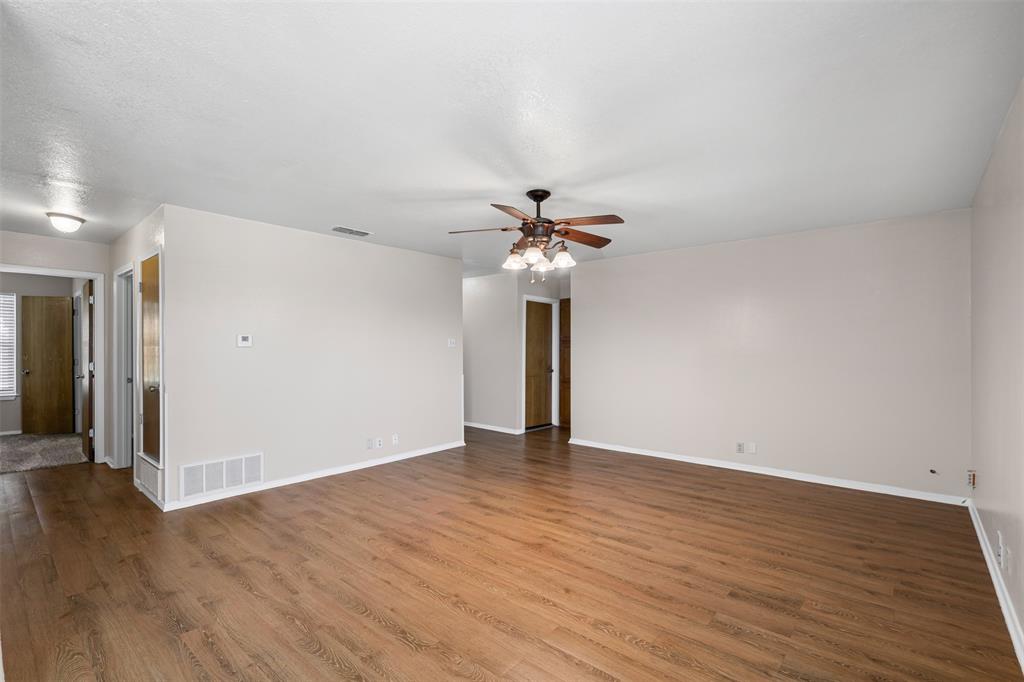 1221 East Fm 4 Cleburne, TX 76031 - Photo 12 of 35 a view of an empty room with wooden floor