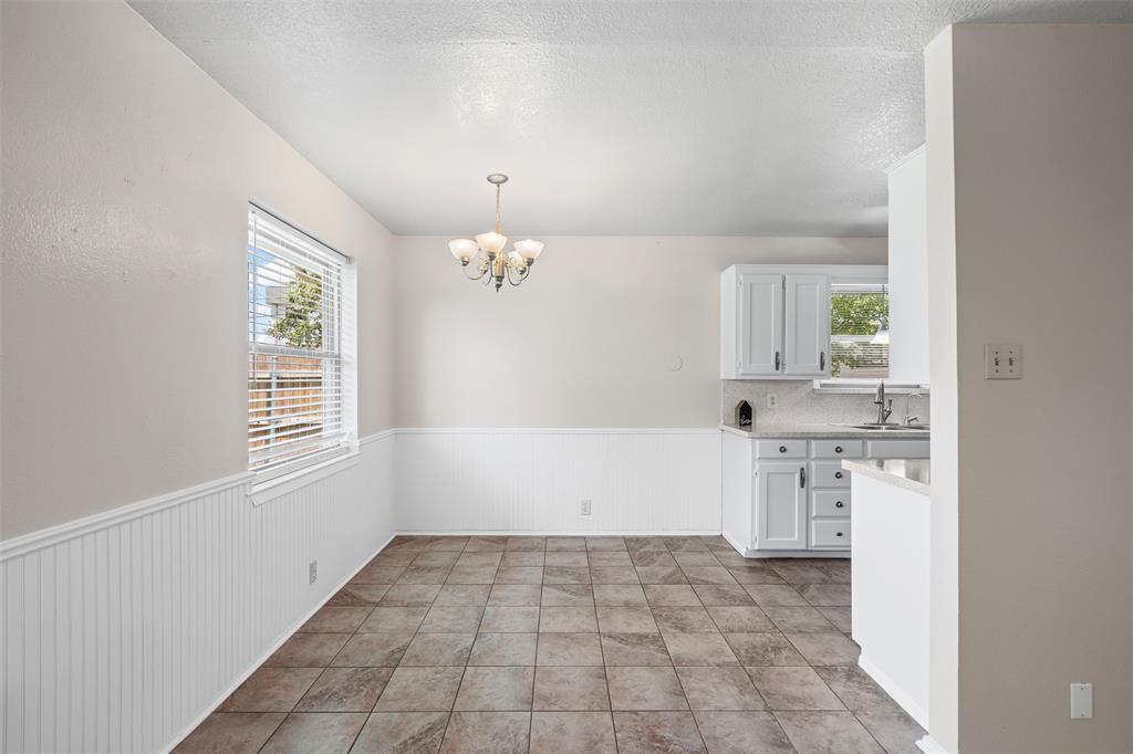 1221 East Fm 4 Cleburne, TX 76031 - Photo 13 of 35 a room with a window and chandelier