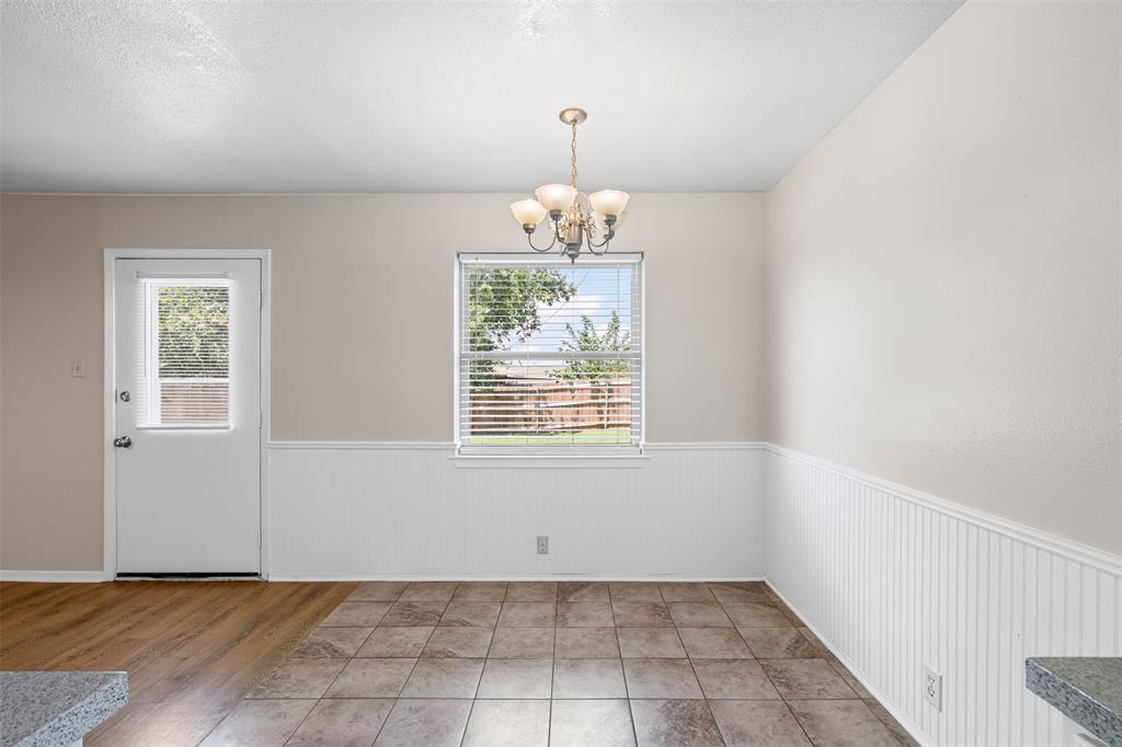 1221 East Fm 4 Cleburne, TX 76031 - Photo 14 of 35 an empty room with chandelier fan and windows