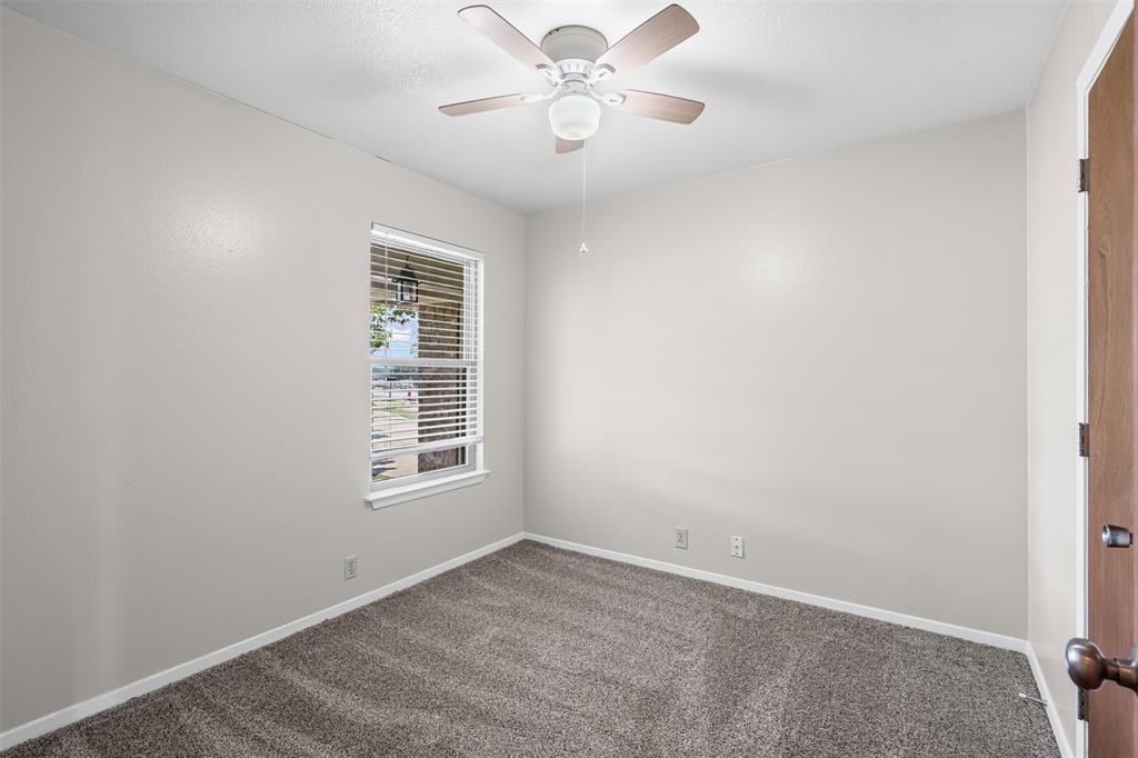 1221 East Fm 4 Cleburne, TX 76031 - Photo 18 of 35 an empty room with chandelier fan and windows