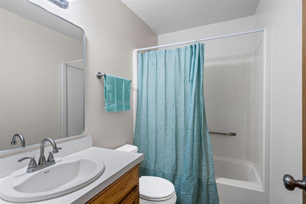 1221 East Fm 4 Cleburne, TX 76031 - Photo 20 of 35 a bathroom with a sink toilet and shower