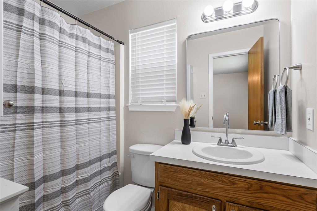 1221 East Fm 4 Cleburne, TX 76031 - Photo 23 of 35 a bathroom with a sink toilet and shower
