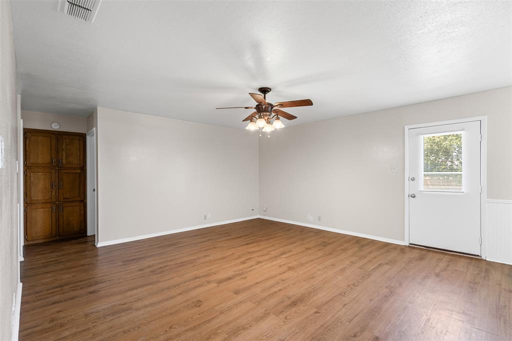 1221 East Fm 4 Cleburne, TX 76031 - Photo 10 of 35 a view of a room with wooden floor and a ceiling fan