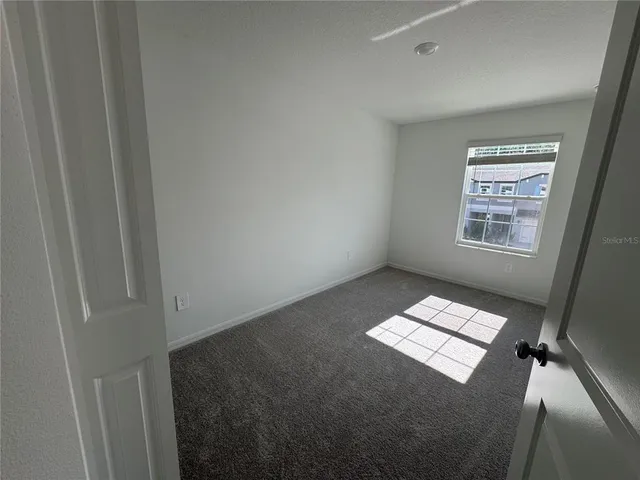 a view of room with window and stairs