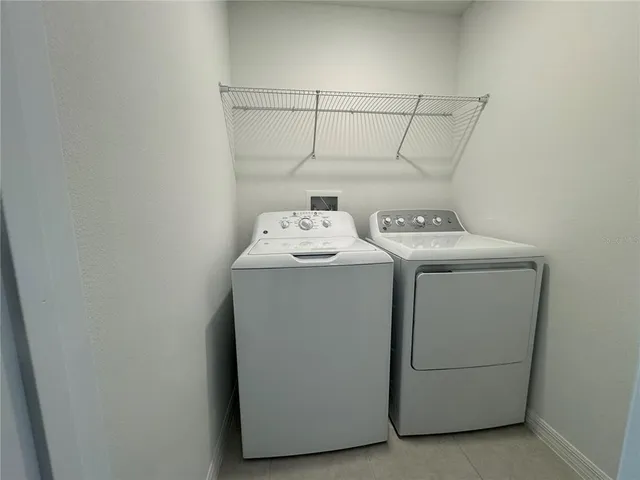 a bathroom with a shower sink vanity and mirror