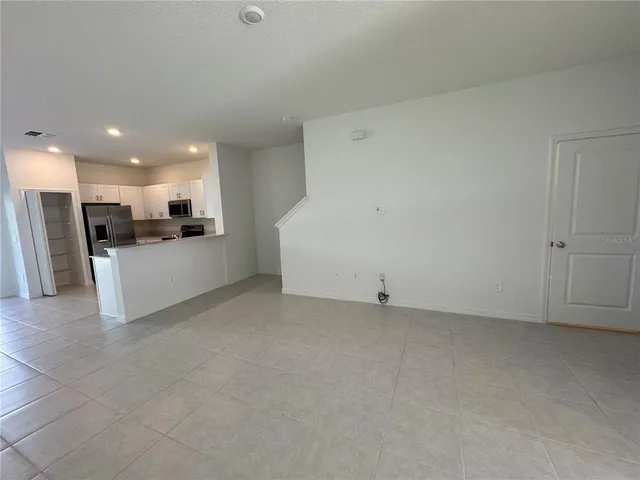 a view of a kitchen with a sink and a refrigerator