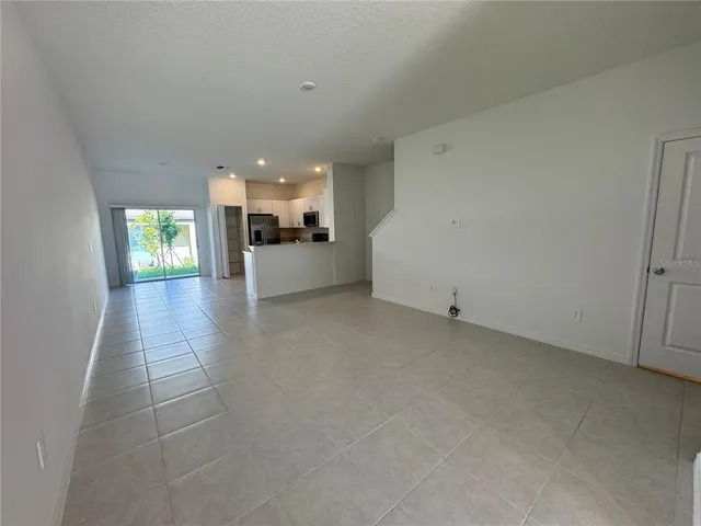 a view of a kitchen with furniture and an empty room