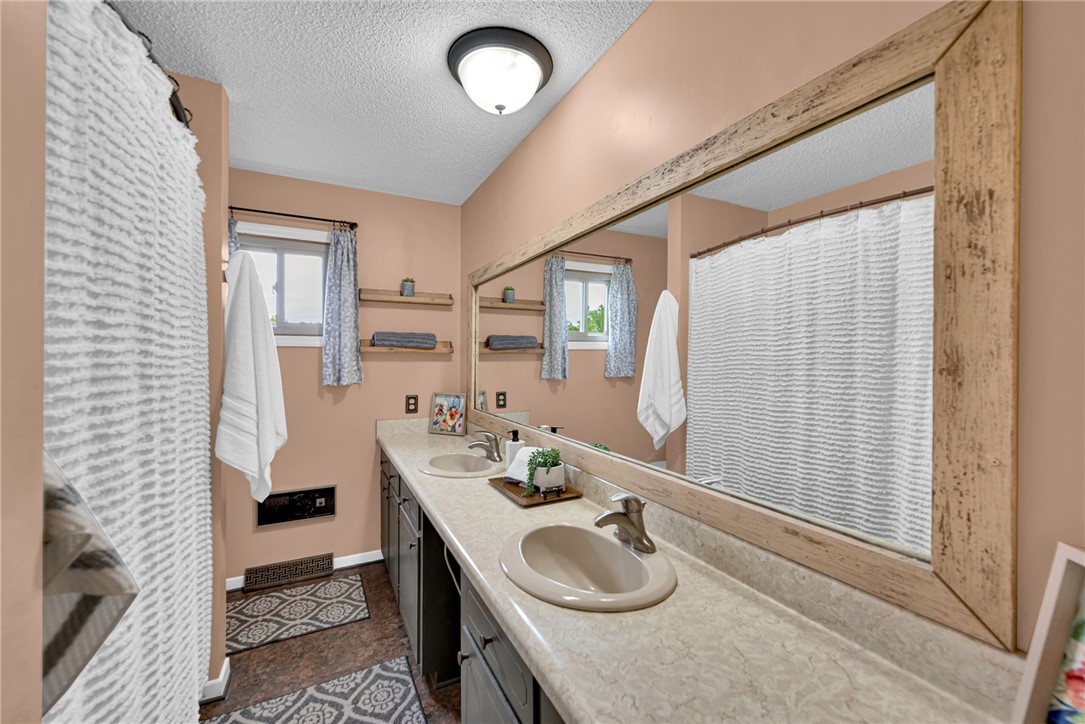 433 Latham Road Easley, SC 29640 - Photo 25 of 50 Double vanities with sleek countertops and abundant lighting create a refreshed bathroom experience.