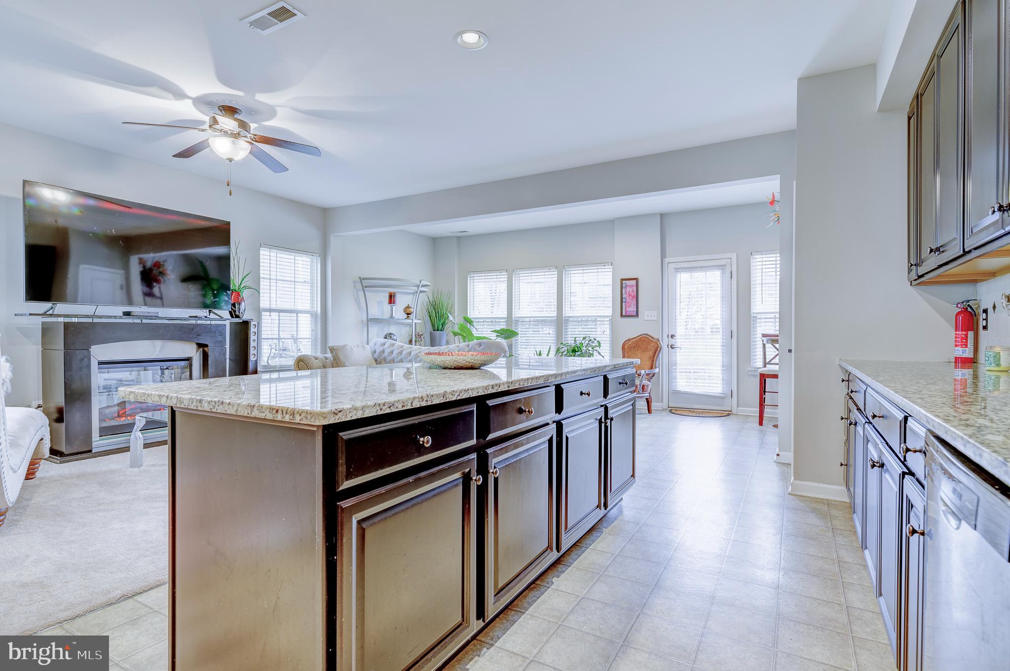 81 Sundance Drive Hamilton, NJ 08619 - Photo 13 of 44 a kitchen with kitchen island granite countertop a sink appliances and cabinets